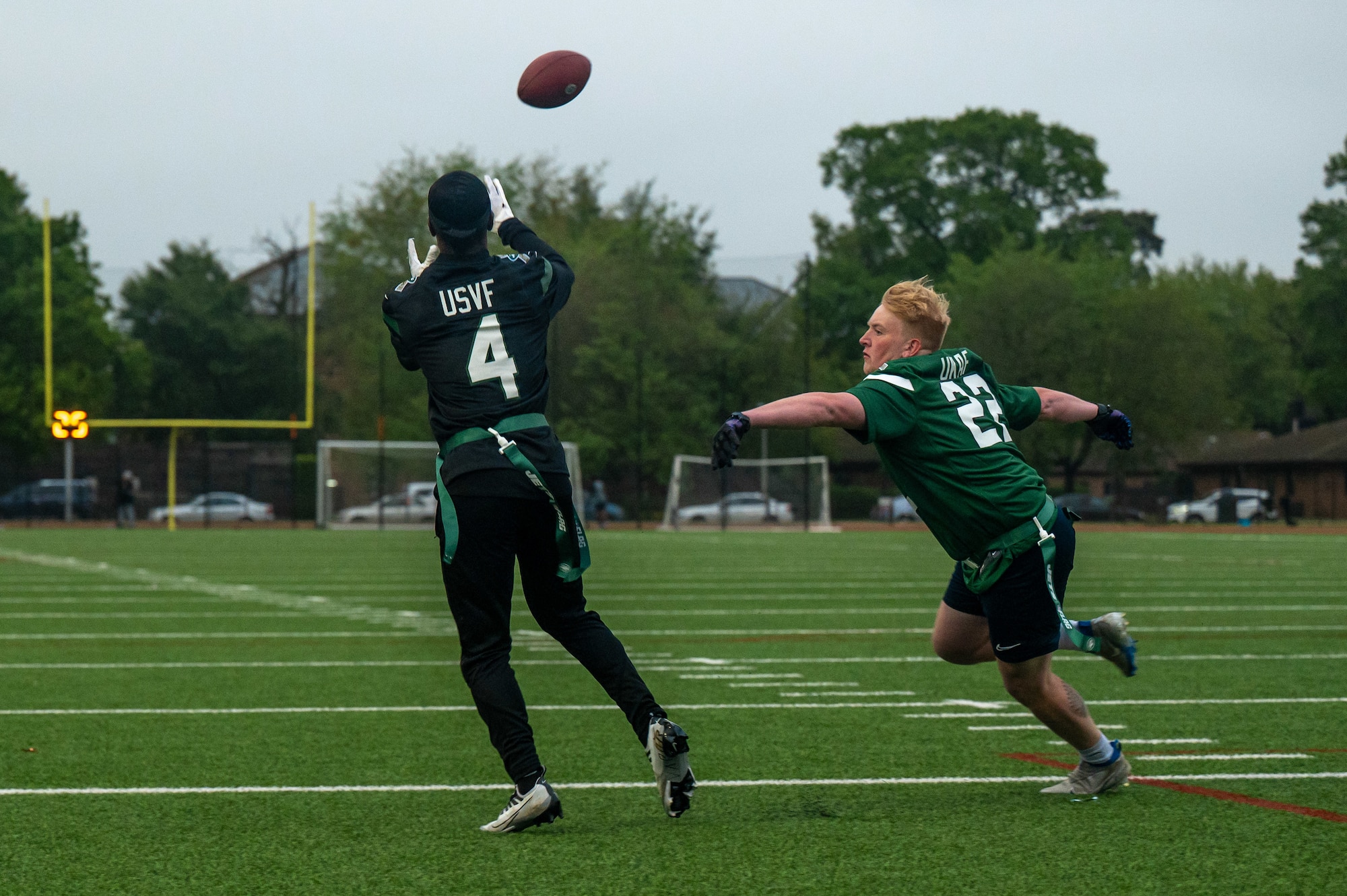U.S. Senior Airman Joshua Hartman, assigned to the 48th Security Forces Squadron, catches a pass during a flag football game against a U.K. Armed Forces team at Royal Air Force Lakenheath, England, May 12, 2023. The flag football game, hosted by the New York Jets and the Armed Forces Flag Football Association, was intended to foster an environment where both teams could participate in a shared activity to promote teamwork, communication and mutual respect. (U.S. Air Force photo by Airman 1st Class Seleena Muhammad-Ali)