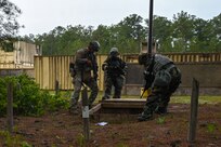 U.S. Airmen from the South Carolina Air National Guard and other Air National Guard units discover a trapdoor and tunnel during Emergency Management Battlefield Expeditionary Response training at McCrady Training Center, Eastover, South Carolina, May 5, 2023. The Airmen practiced responses to simulated chemical, biological, radiological and nuclear events.