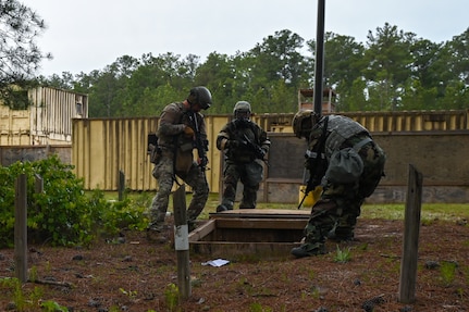 U.S. Airmen from the South Carolina Air National Guard and other Air National Guard units discover a trapdoor and tunnel during Emergency Management Battlefield Expeditionary Response training at McCrady Training Center, Eastover, South Carolina, May 5, 2023. The Airmen practiced responses to simulated chemical, biological, radiological and nuclear events.