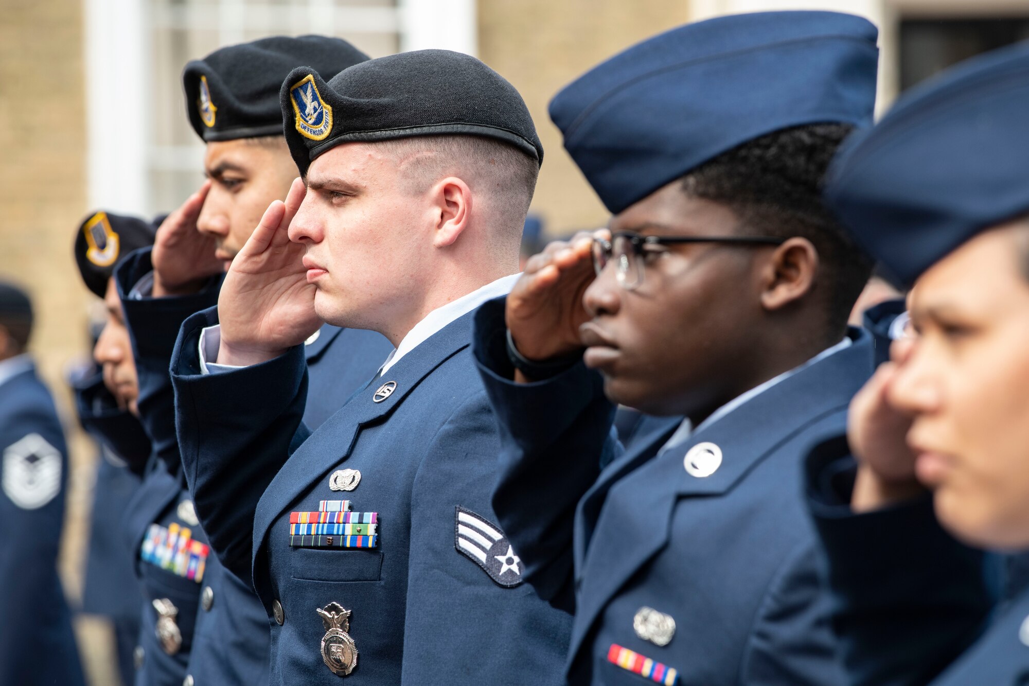 Members of the 501st Combat Support Wing salute during a ceremony in Huntingdon, England