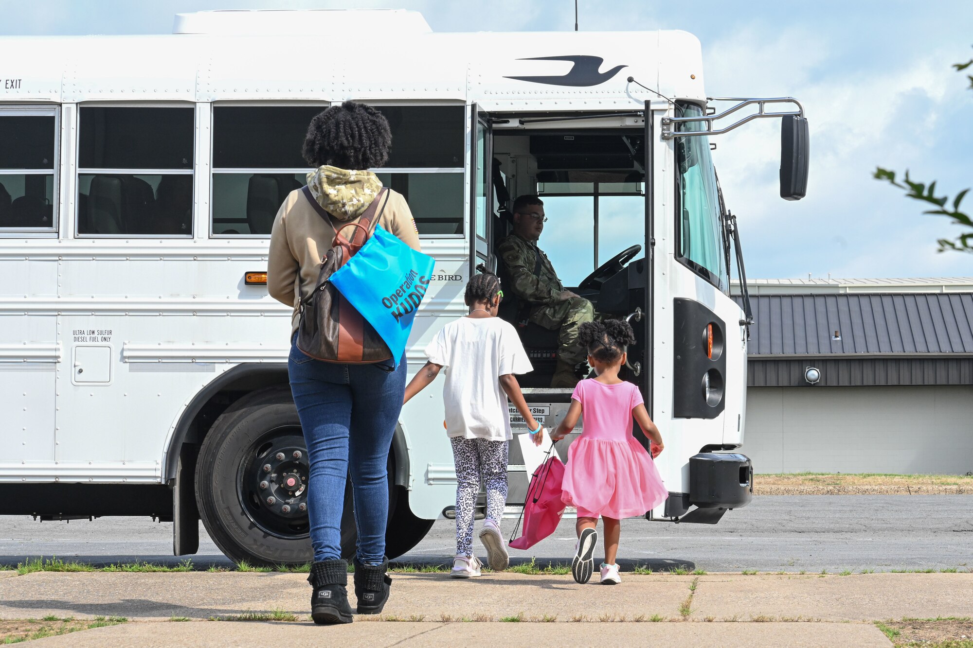 Kids board on a bus during KUDOS.