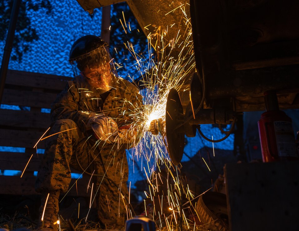 U.S. Marine Corps Cpl. Francisco Vasquez, a motor transportation mechanic with Headquarters and Service Company, 2nd Battalion, 7th Marine Regiment, 1st Marine Division, repairs a trailer during a readiness exercise at Fort Hunter Liggett, California, May 8, 2023. The exercise was designed to enhance the combat and deployment readiness of the battalion, and prepare them to deploy as part of a crisis response force.