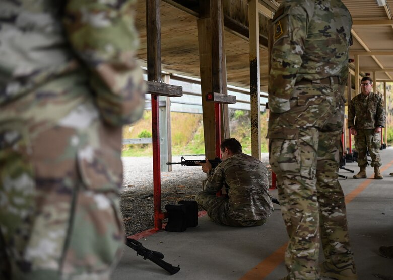 Staff Sgt. William Boyce, 30th Security Forces Squadron combat arms instructor, demonstrates the different positions the competitors they will be instructed to shoot in during the excellence competition at Vandenberg Space Force Base, Calif., May 16, 2023. National Police Week offers honor, remembrance, and peer support while allowing law enforcement, survivors and citizens to gather and pay homage to those who gave their lives in the line of duty. (U.S. Space Force photo by Senior Airman Tiarra Sibley)