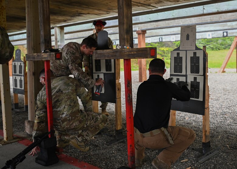 Staff Sgt. William Boyce, 30th Security Forces Squadron combat arms instructor, helps the excellence competitors prepare their targets before the competition at Vandenberg Space Force Base, Calif., May 16, 2023. National Police Week offers honor, remembrance, and peer support while allowing law enforcement, survivors and citizens to gather and pay homage to those who gave their lives in the line of duty. (U.S. Space Force photo by Senior Airman Tiarra Sibley)