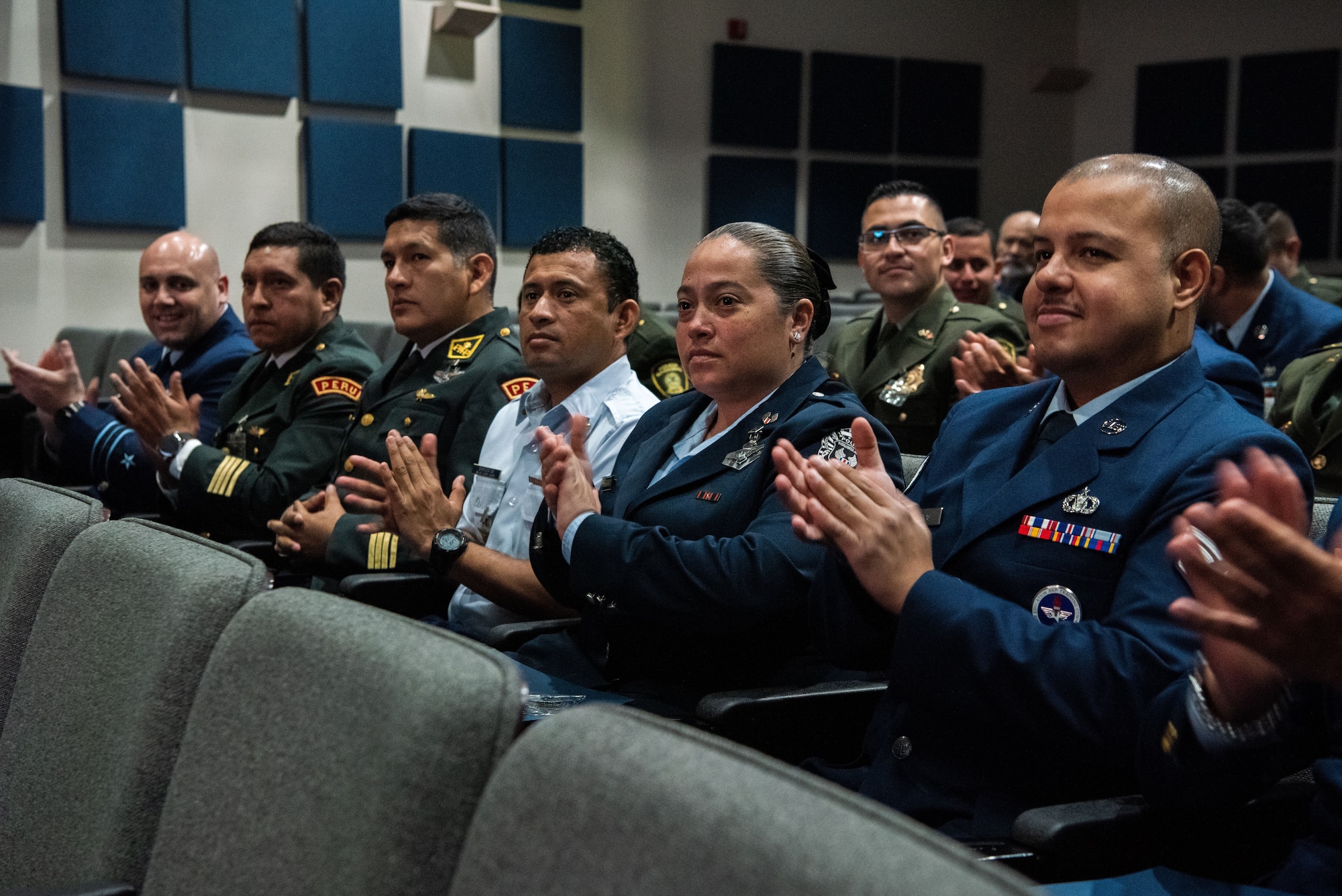 IAAFA graduates clap during graduation ceremony at JBSA-Lackland, Texas, April 26, 2023. 
More than 60 international military students from seven partner nations and the USAF graduated during the first training cycle of 2023. IAAFA provides instruction in professional military education and leadership, aircrew training and technical courses – all in Spanish. (U.S. Air Force photo by Vanessa R. Adame)