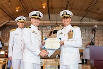 Capt. Gregory Petrovic (right), U.S. Naval Research Laboratory (NRL) commanding officer, presents a Meritorious Service Medal to Cmdr. Jeffrey Webb (left), NRL’s Scientific Development Squadron (VXS) 1 outgoing commanding officer, during the VXS 1 change of command ceremony at Naval Air Station Patuxent River in Patuxent River, Maryland, May 18, 2023. (U.S. Navy photo by Sarah Peterson)