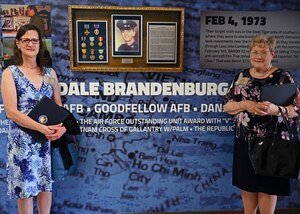 U.S. Air Force Sgt. Dale Brandenburg’s sister-in-law, Amelia Brandenburg, admires a memorial during the rededication at Brandenburg Hall, Goodfellow Air Force Base, Texas, May 12, 2023. The building was originally dedicated in 2014. (U.S. Air Force photo by Senior Airman Sarah Williams)