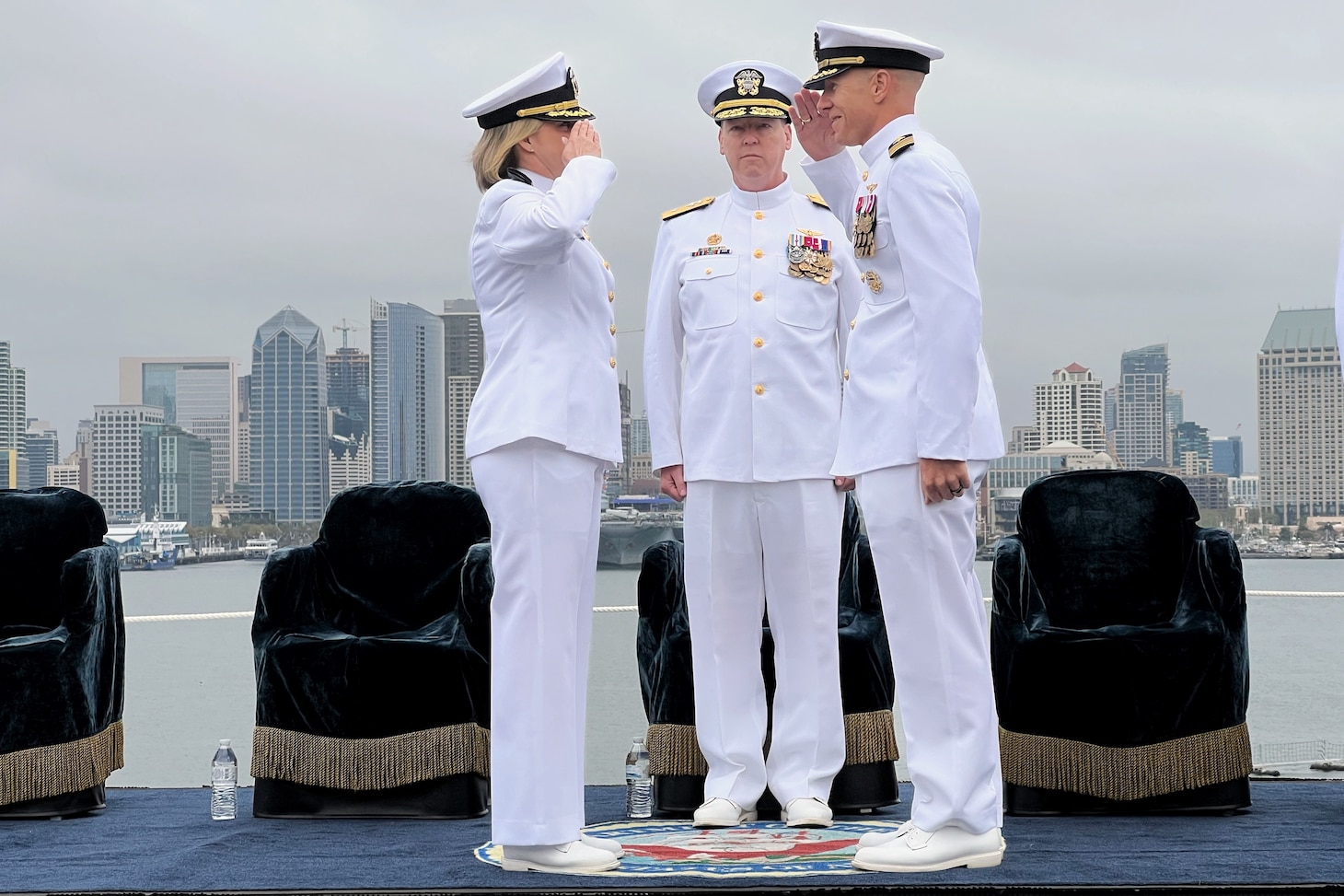 Capt. Peter J. Riebe, right, relieves Capt. Amy N. Bauernschmidt, left, as commanding officer of the Nimitz-class aircraft carrier USS Abraham Lincoln (CVN 72) during a change of command ceremony presided by Rear Adm. Kevin Lenox, commander, Carrier Strike Group 3, on the flight deck.