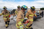 Firefighters with the 167th Civil Engineering Squadron carry a litter with a simulated patient from a staged car accident as part of an all-hazards training event at the 167th Airlift Wing May 4, 2023. Emergency responders with the 167th AW participated in the Counter CBRN (Chemical, Biological, Radiological and Nuclear) All-Hazard Management Response course May 1-5, 2023, at the Martinsburg, West Virginia, air base.