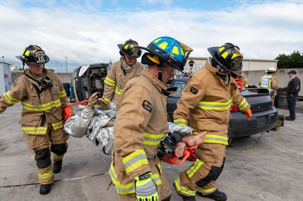 Firefighters with the 167th Civil Engineering Squadron carry a litter with a simulated patient from a staged car accident as part of an all-hazards training event at the 167th Airlift Wing May 4, 2023. Emergency responders with the 167th AW participated in the Counter CBRN (Chemical, Biological, Radiological and Nuclear) All-Hazard Management Response course May 1-5, 2023, at the Martinsburg, West Virginia, air base.