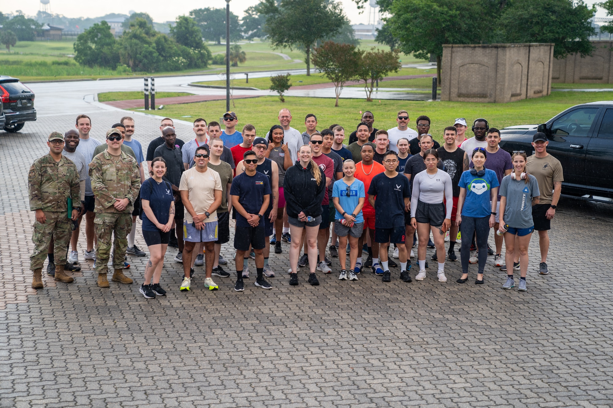 Airmen pose for a group photo before running in the Air Force Assistance Fund 5K at Keesler Air Force Base, Mississippi, May 19, 2023.