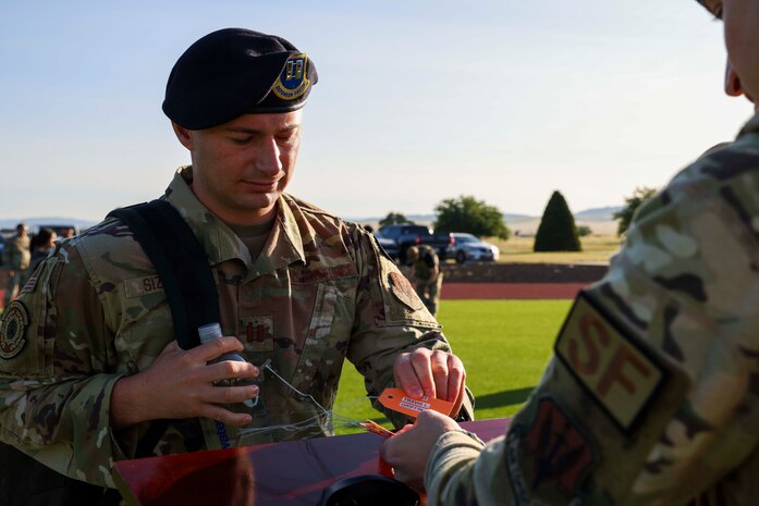 U.S. Air Force Capt. Ricky Sizemore, 9th Security Forces Squadron operations officer, receives a name tag before a 9K ruck march in honor of National Police Week, on May 15, 2023, at Beale Air Force Base, California.