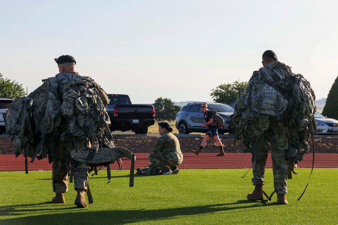 U.S. Air Force members Master Sgt. Smith, 9th Security Forces Squadron delta flight chief (left) and Staff Sgt. Dillon Rafferty, 9th Security Forces Squadron delta flight sergeant, carry rucksacks during the police week 9K ruck march on May 15, 2023, at Beale Air Force Base, California.