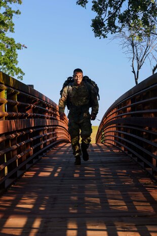 U.S. Air Force Senior Master Sgt. David Martinez, 9th Security Forces Squadron senior enlisted leader, crosses a bridge during the National Police Week 9K ruck march on May 15, 2023, at Beale Air Force Base, California.