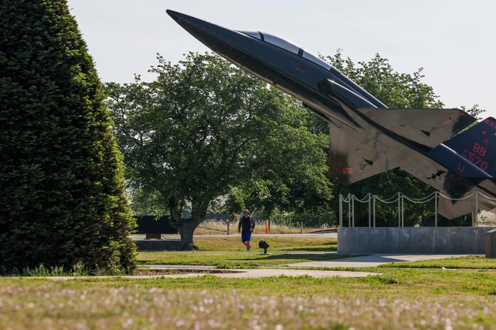 U.S. Air Force Col. James Peterson, 9th Mission Support Group commander, runs past a T-38A Talon static display during the police week 9K ruck march on May 15, 2023, at Beale Air Force Base, California.