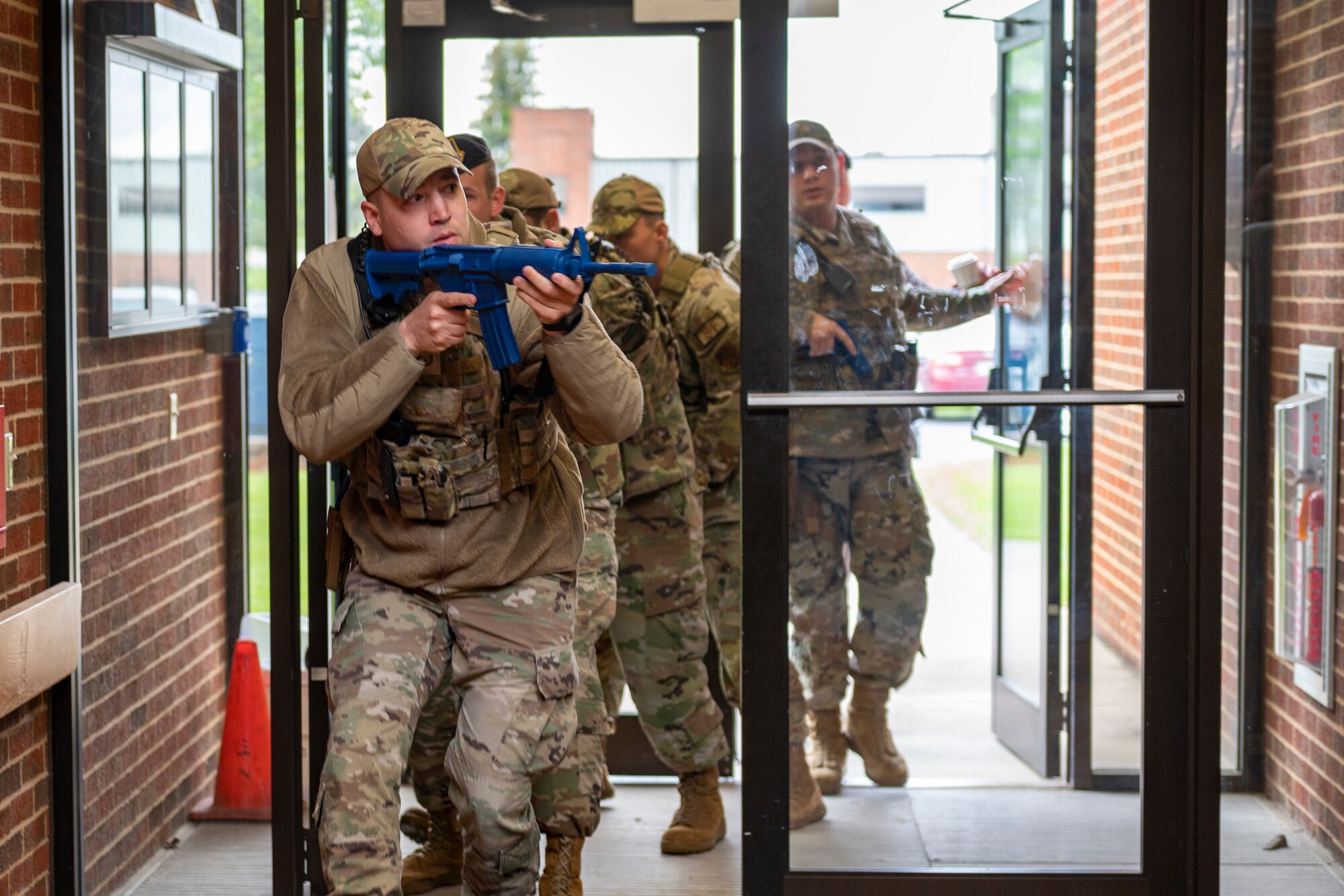 Tech. Sgt. Colton Brandenberg, 167th Security Forces Squadron, leads a team of defenders into a building during an active shooter exercise during an all-hazards training event at the 167th Airlift Wing, May 4, 2023. 167th Airlift Wing emergency responders participated in CAMR, or Counter CBRN (Chemical, Biological, Radiological, and Nuclear) All-Hazard Management Response course 1-5 May at the Martinsburg, West Virginia air base