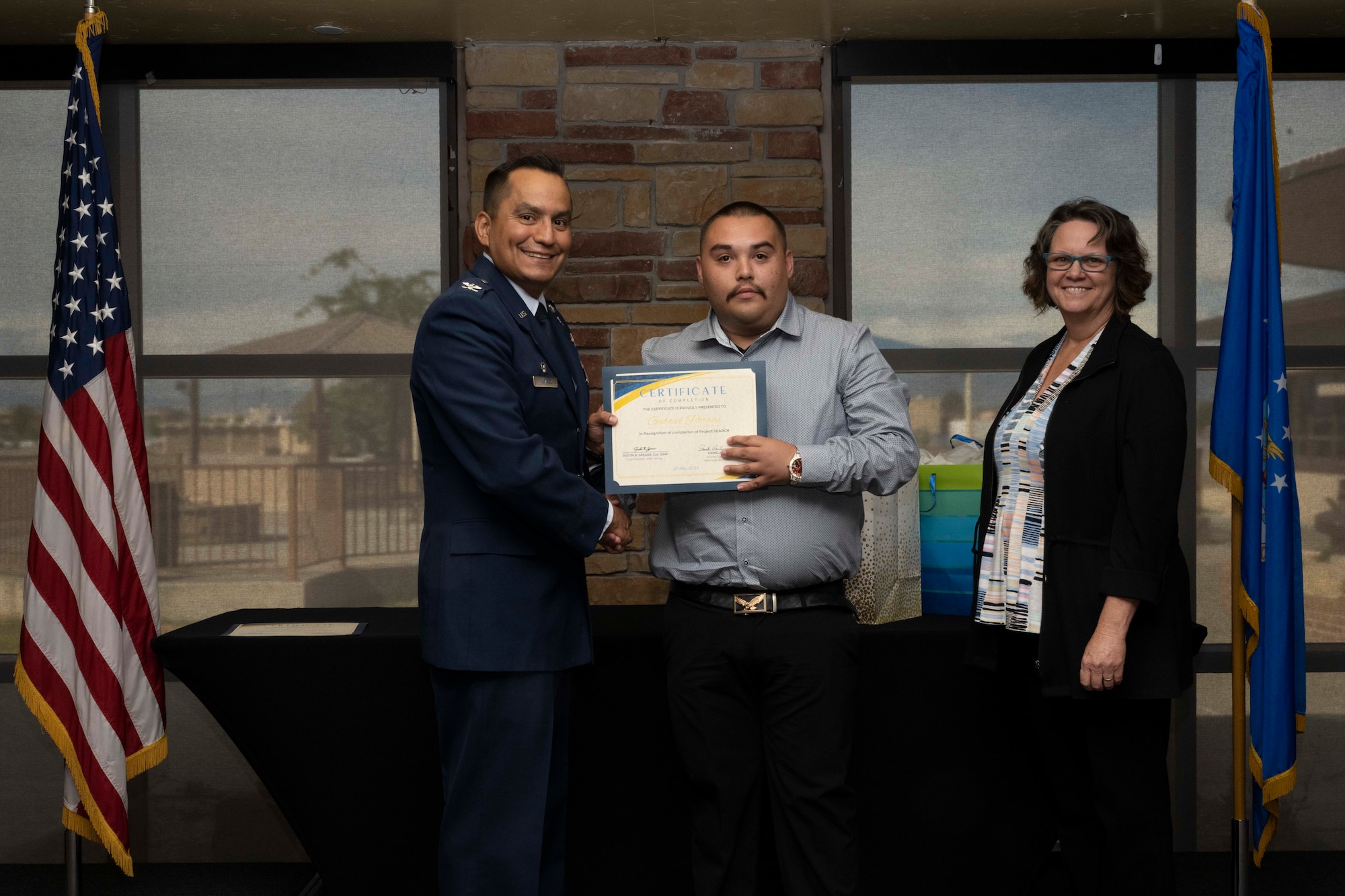Gabriel Porras, Project SEARCH intern, accepts a graduation certificate for completing the Project Search program at Holloman Air Force Base, New Mexico, May 18, 2023.  Project SEARCH integrates 18-22 year olds with disabilities into working environments to help them gain valuable work experience.  (U.S. Air Force photo by Airman 1st Class Michelle Ferrari)