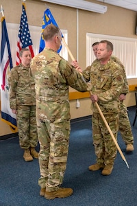 U.S. Air Force Col. Christopher Siegler, 167th Operations Group commander, passes the unit guidon to Lt. Col. George Fay, 167th Airlift Squadron commander as part of a change of command ceremony at the 167th Airlift Wing dining facility, Martinsburg, West Virginia, May 7, 2023. Fay takes command of the 167th Airlift Squadron with nearly 20 years of experience in multiple capacities in the Air Force and Air National Guard.