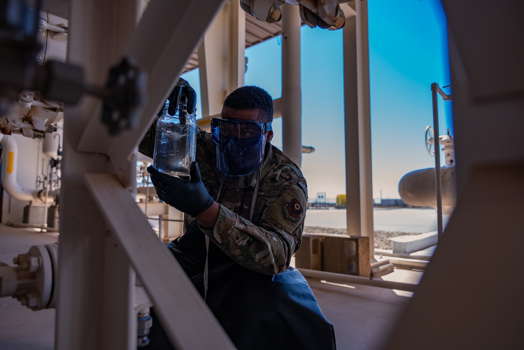 U.S. Air Force Senior Airman Jalen Price, 27th Special Operations Logistic Readiness Squadron Fuels Management Flight facilities Airman, checks the clarity of fuel at Cannon Air Force Base, N.M., April 14, 2023. The 27th LRS was awarded the first place 2022 American Petroleum Institute Award by the U.S. Air Force for the Best Fuels Organization out of 78 flights. (U.S. Air Force photo by Senior Airman Alexcia Givens)