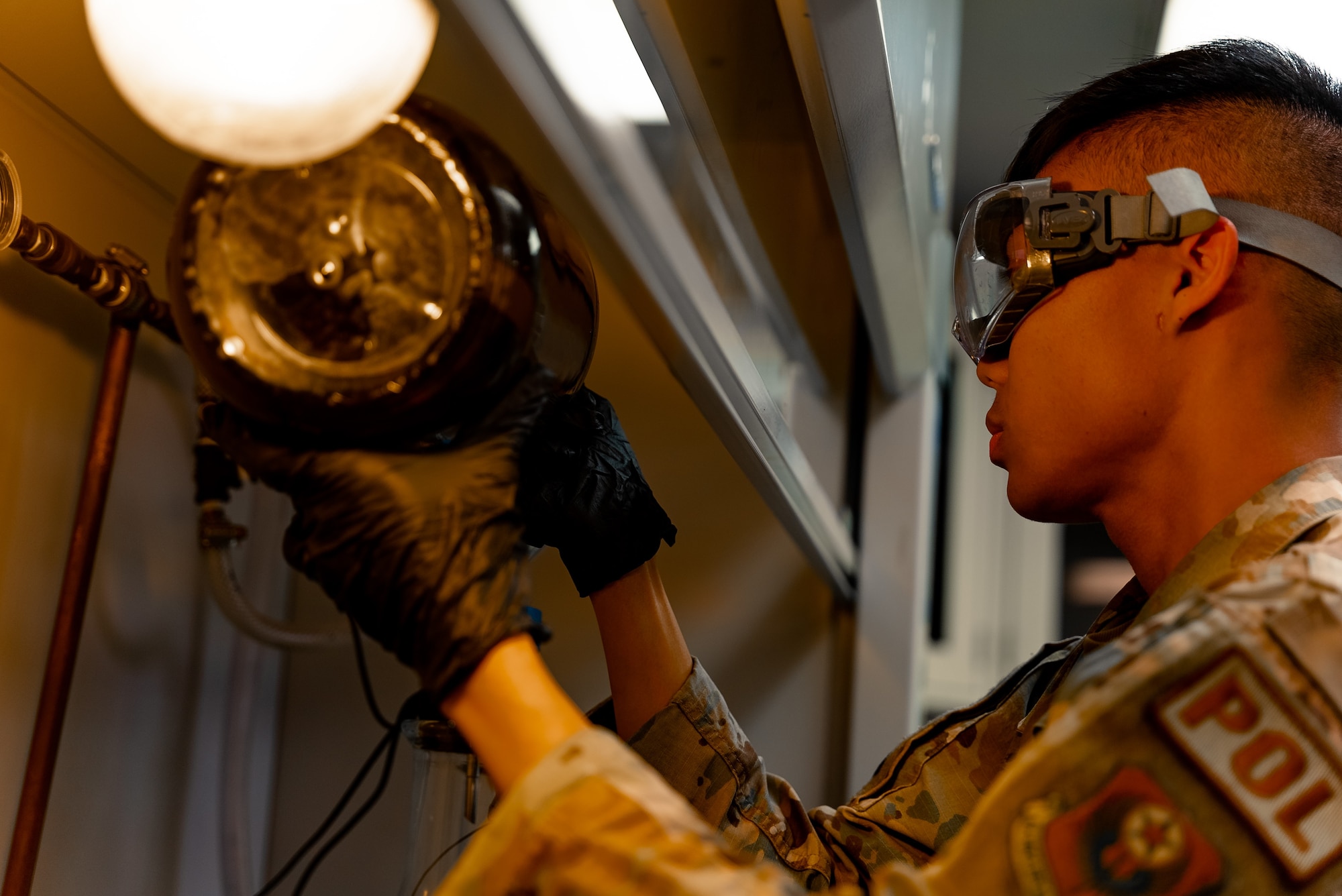 U.S. Air Force Senior Airman Kien Luong, 27th Special Operations Logistic Readiness Squadron Fuels Management Flight fuels laboratory technician, tests fuel samples in a laboratory to ensure its quality at Cannon Air Force Base, N.M., April 14, 2023. The 27th LRS was awarded the first place 2022 American Petroleum Institute Award by the U.S. Air Force for the Best Fuels Organization out of 78 flights. (U.S. Air Force photo by Senior Airman Alexcia Givens)