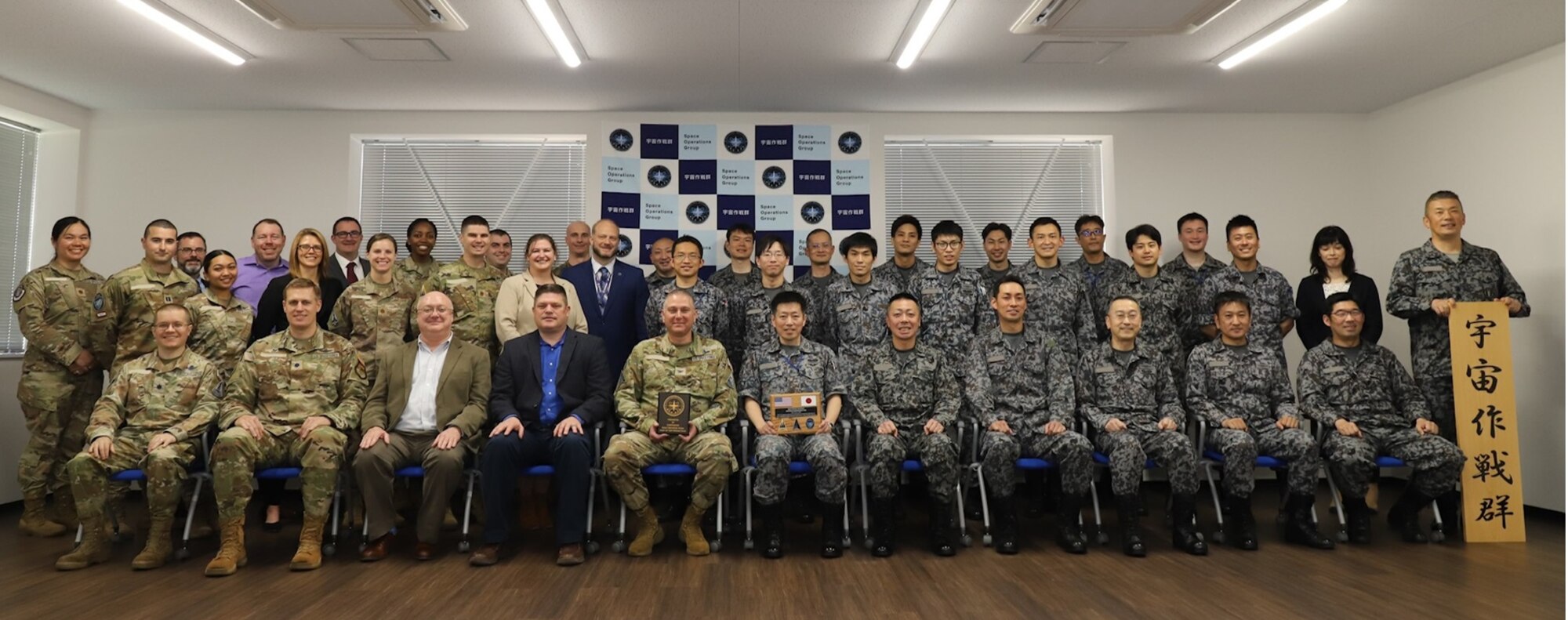 People gathered in a room for a group photo.