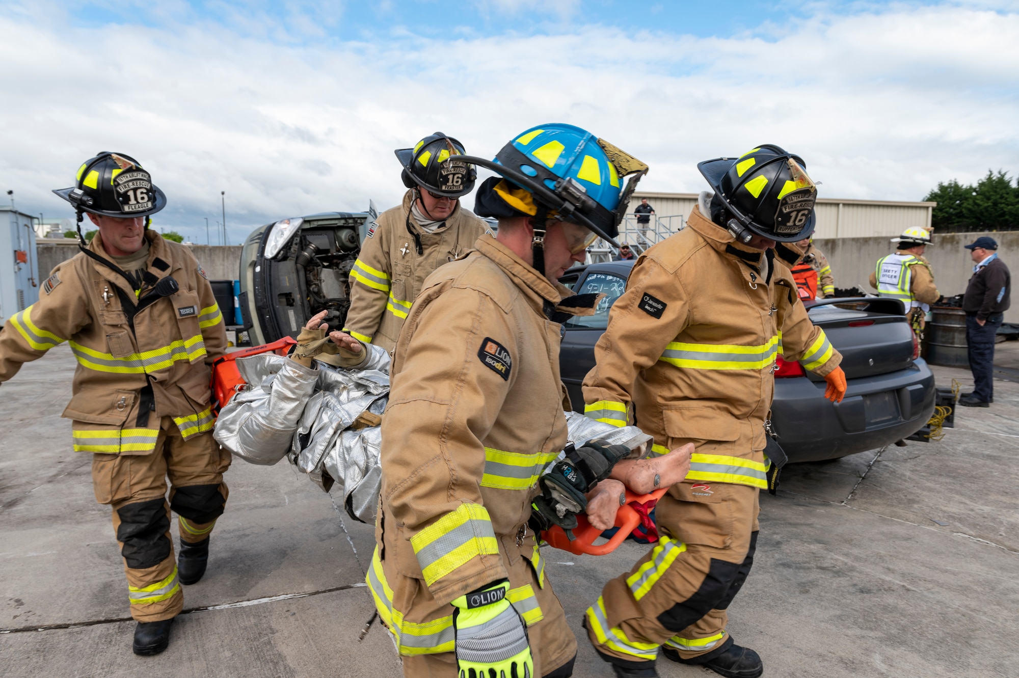 Firefighters with the 167th Civil Engineering Squadron carry a litter with a simulated patient from a staged car accident as part of an all-hazards training event at the 167th Airlift Wing May 4, 2023. Emergency responders with the 167th AW participated in the Counter CBRN (Chemical, Biological, Radiological and Nuclear) All-Hazard Management Response course May 1-5, 2023, at the Martinsburg, West Virginia, air base.