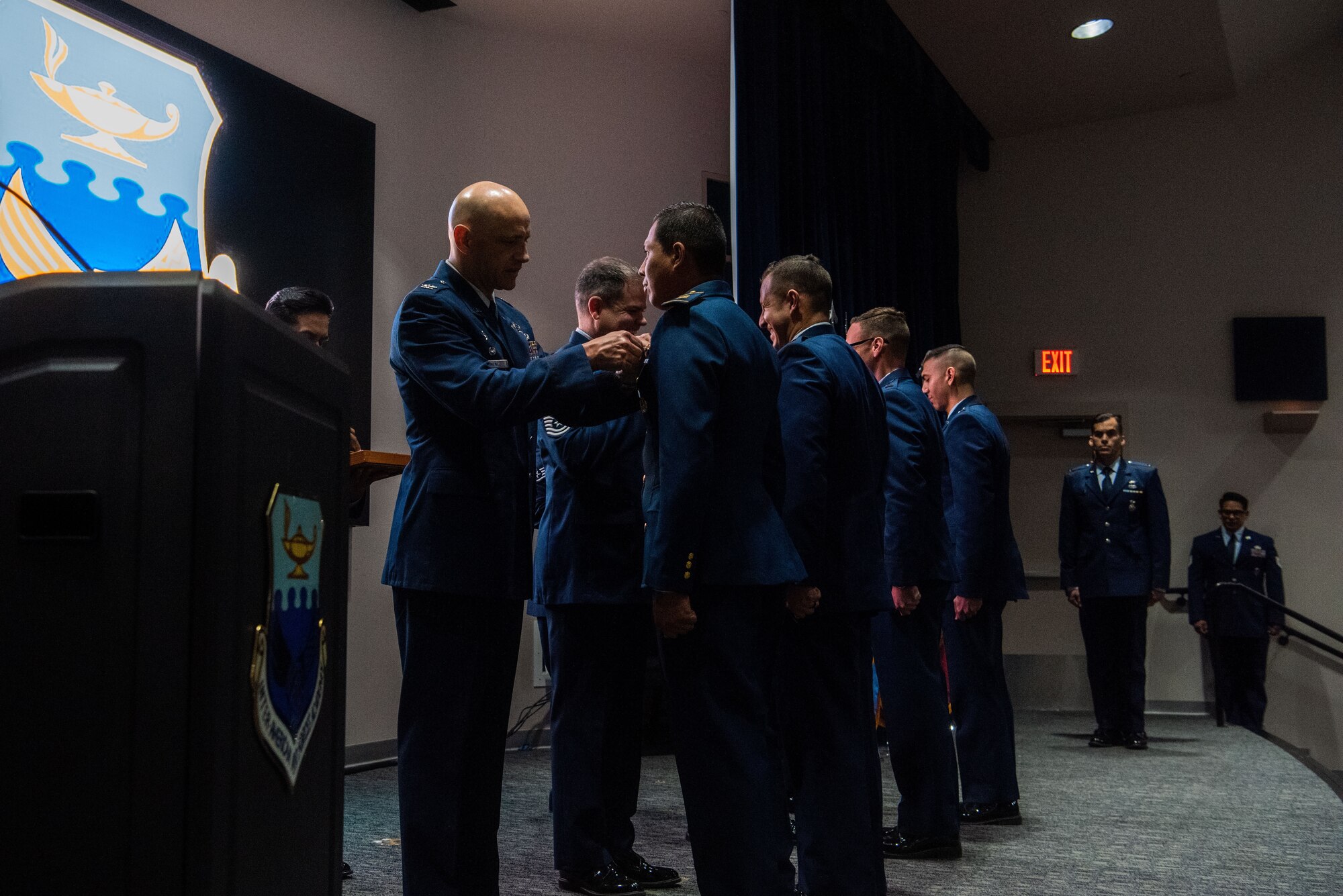 Col. José Jiménez, Jr., commandant of the Inter-American Air Forces Academy, pins international military student during IAAFA’s graduation banquet and 80th anniversary celebration, at San Antonio, Texas, April 26, 2023. More than 60 international military students from seven partner nations and the USAF graduated during the first training cycle of 2023. IAAFA provides instruction in professional military education and leadership, aircrew training and technical courses – all in Spanish. (U.S. Air Force photo by Vanessa R. Adame)