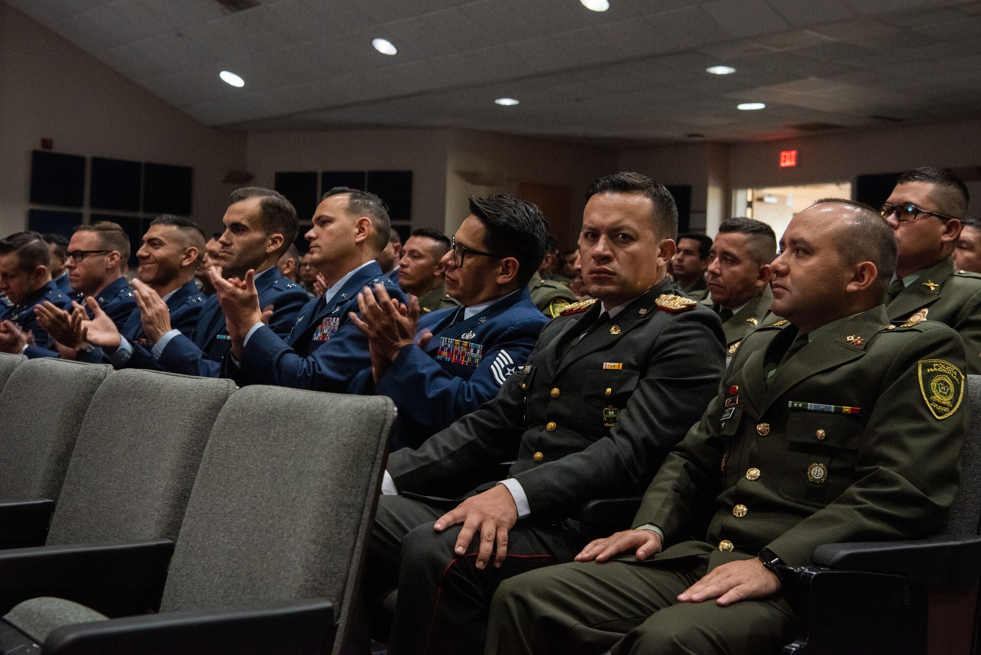 An international military student glances at the camera during the IAAFA graduation ceremony at JBSA-Lackland, Texas, April 26, 2023. More than 60 international military students from seven partner nations and the USAF graduated during the first training cycle of 2023. IAAFA provides instruction in professional military education and leadership, aircrew training and technical courses – all in Spanish. (U.S. Air Force photo by Vanessa R. Adame)