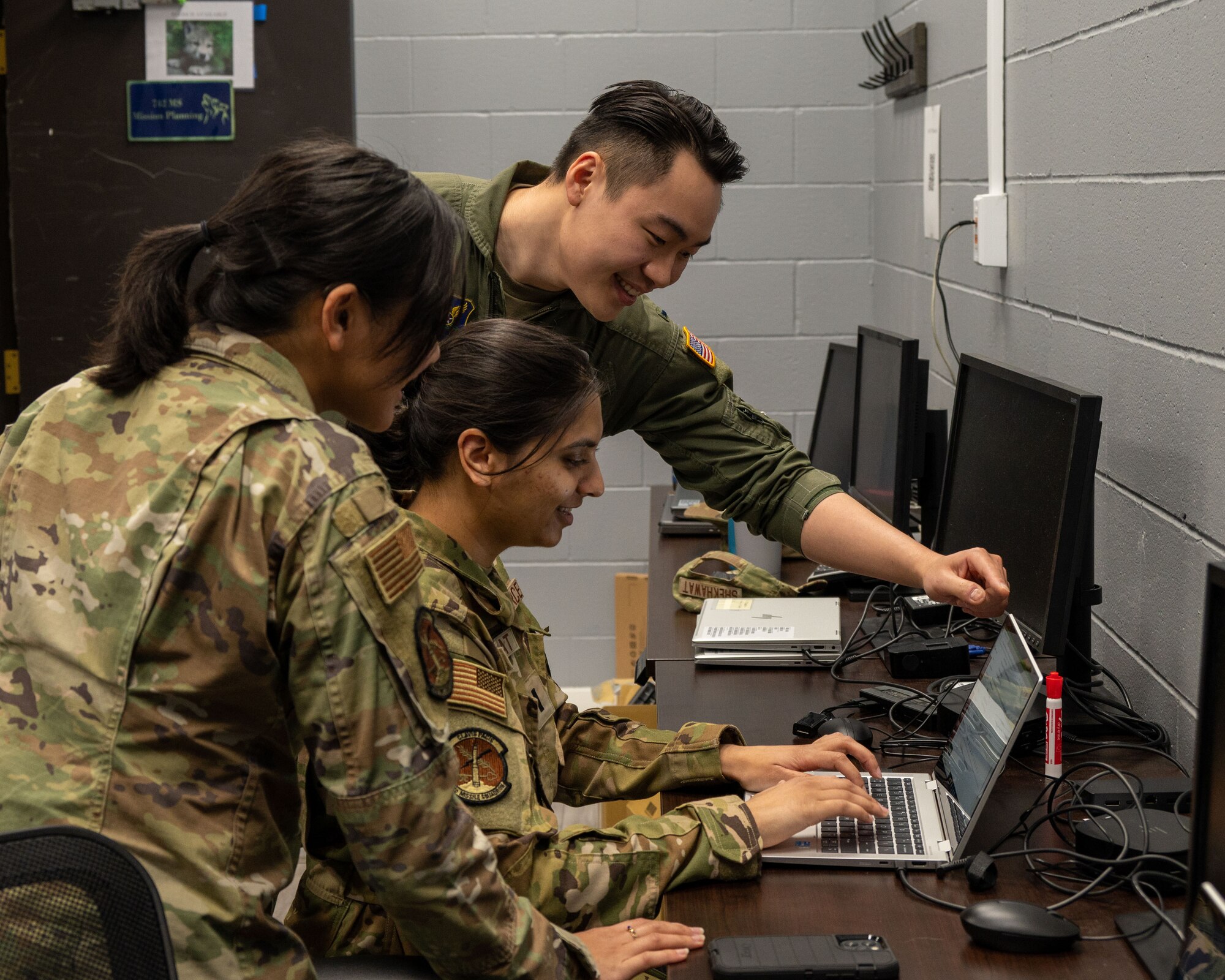 1st Lt. Aaron Chen, Nuclear and Missiles Operations officer, discusses mission planning with his colleagues at Minot Air Force Base, North Dakota, May 5, 2023. Mission planning is responsible for organizing and going through daily events to ensure all operations run smoothly. (U.S. Air Force photo by Senior Evan Lichtenhan)