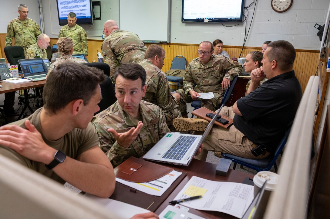 Senior Airmen Steven Heaton and Craig Sipes, 167th Emergency Management, discuss emergency response procedures in the 167th Airlift Wing’s Emergency Operations Center as part of an all-hazards training event at the 167th Airlift Wing, May 4, 2023. 167th Airlift Wing emergency responders participated in CAMR, or Counter CBRN (Chemical, Biological, Radiological, and Nuclear) All-Hazard Management Response course 1-5 May at the Martinsburg, West Virginia air base.