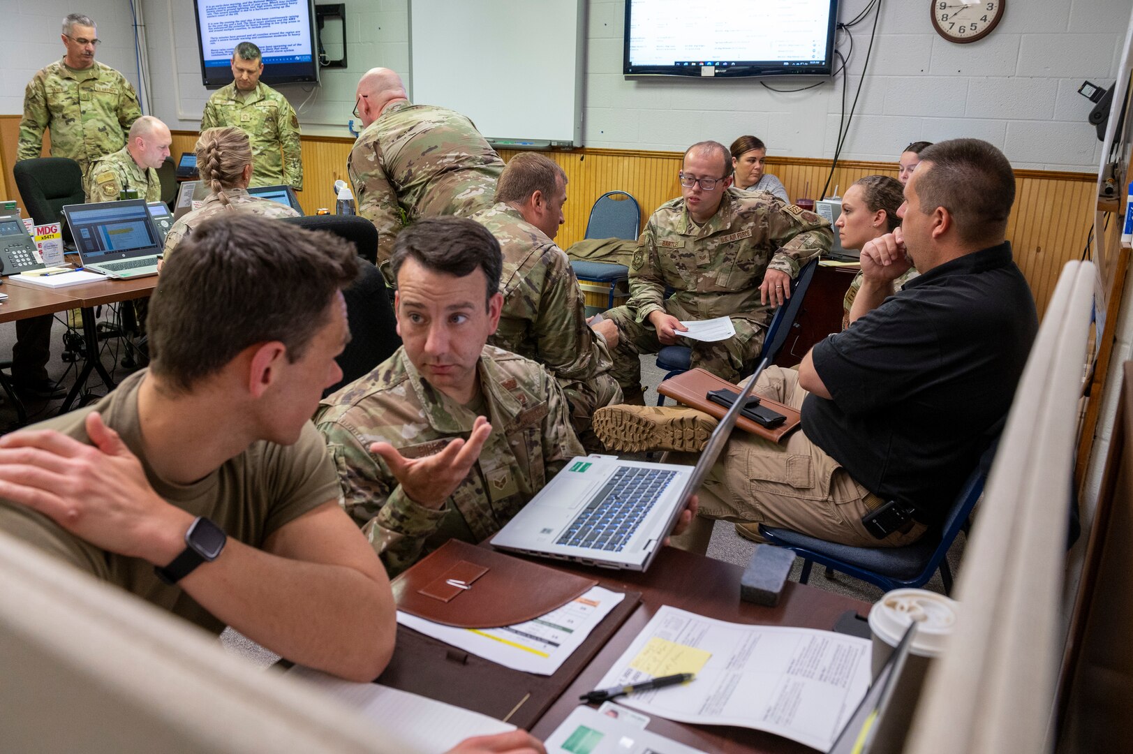Senior Airmen Steven Heaton and Craig Sipes, 167th Emergency Management, discuss emergency response procedures in the 167th Airlift Wing’s Emergency Operations Center as part of an all-hazards training event at the 167th Airlift Wing, May 4, 2023. 167th Airlift Wing emergency responders participated in CAMR, or Counter CBRN (Chemical, Biological, Radiological, and Nuclear) All-Hazard Management Response course 1-5 May at the Martinsburg, West Virginia air base.