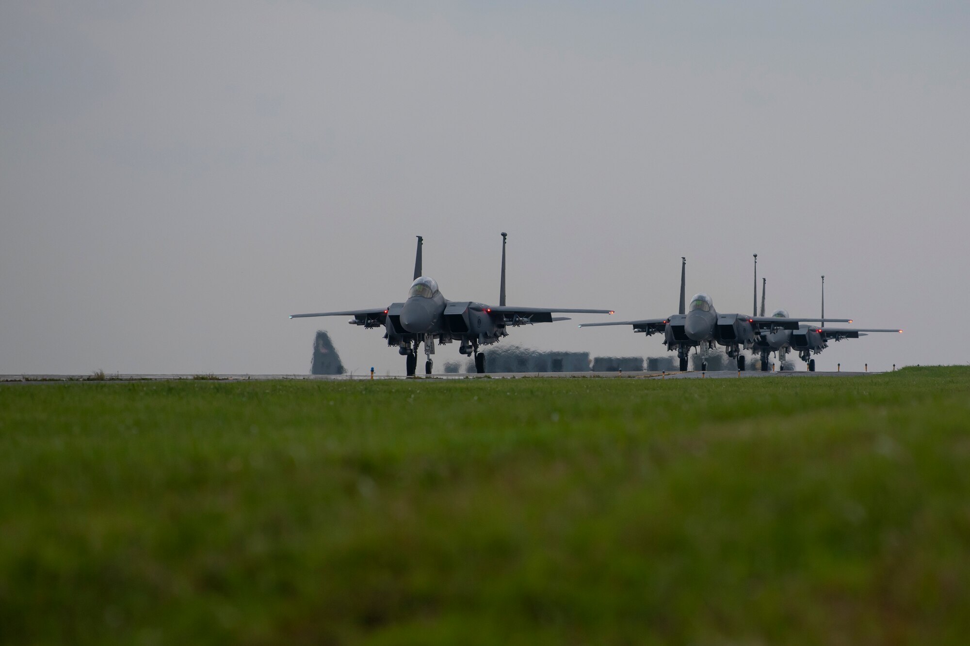 F-15E Strike Eagles assigned to the 336th Fighter Squadron taxi down the flightline at Kadena Air Base, Japan, May 17, 2023. Throughout the week, the Strike Eagles flew evening sorties in support of the bilateral exercise, Southern Beach. Night flying operations hone the skills necessary for aircrew to successfully fly and fight in low to no visibility environments. (U.S. Air Force photo by Staff Sgt. Jessi Roth)