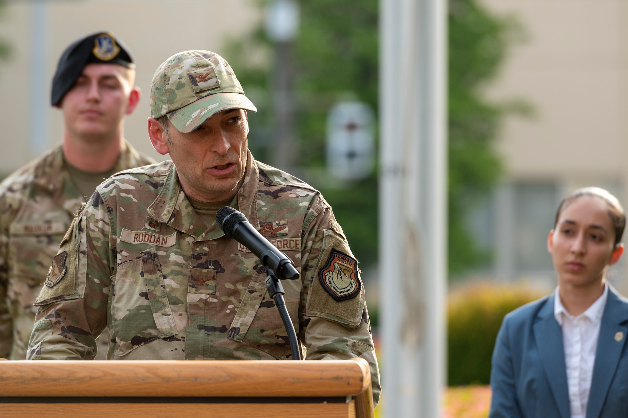 a older uniformed man speaks into a microphone