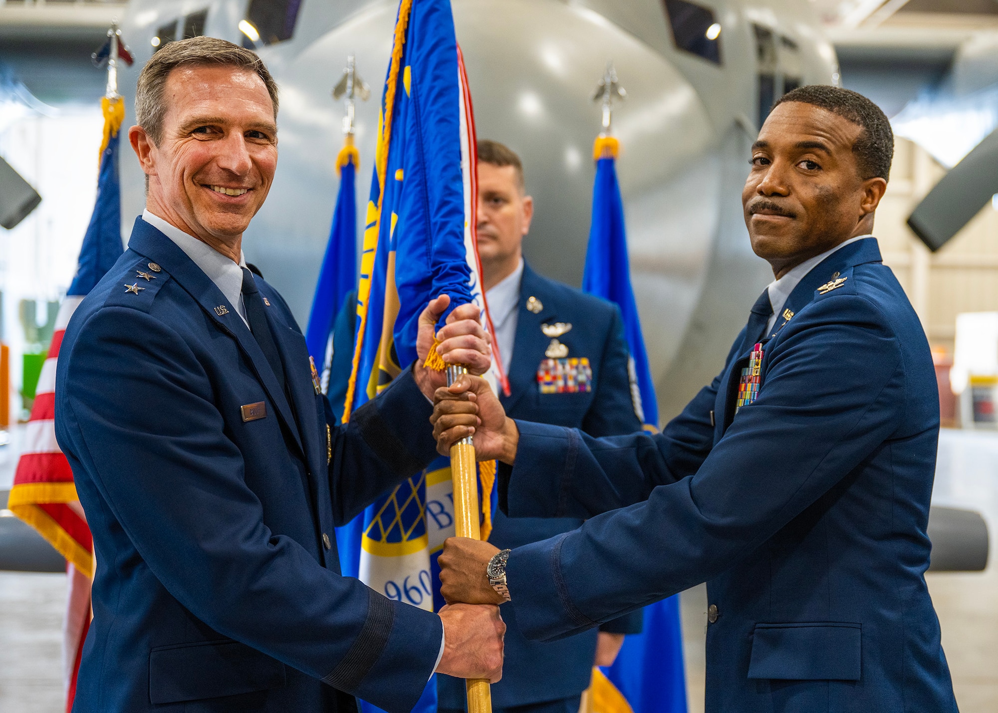 Col. Silas V. Darden receives the guidon from Maj. Gen. Bryan P. Radliff, 10th Air Force commander, after he assumes command from Col. Richard A. Erredge, 960th CW outgoing commander, during the 960th Cyberspace Wing change of command ceremony at Joint Base San Antonio-Lackland, Texas on May 7, 2023. (U.S. Air Force photo by Brian Boisvert)