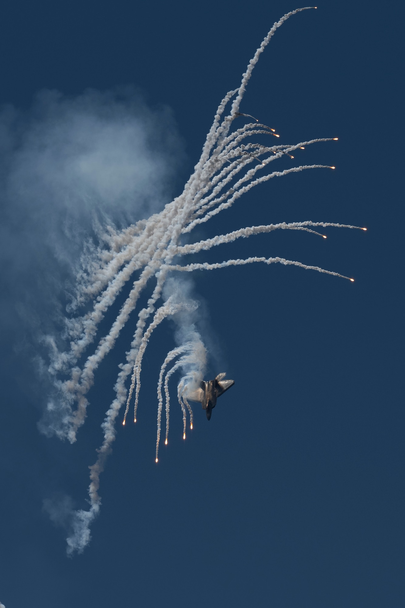 An F-22 Raptor assigned to the 1st Fighter Wing F-22 Demo Team, performs an aerial routine during the Wings Over Wayne Air Show at Seymour Johnson Air Force Base, North Carolina, May 20, 2023. Wings Over Wayne provides an opportunity for North Carolina residents and visitors from around the world to see how SJAFB builds to the future of airpower and displays a history of aircraft innovation and capabilities. (U.S. Air Force photo by Senior Airman Kevin Holloway)