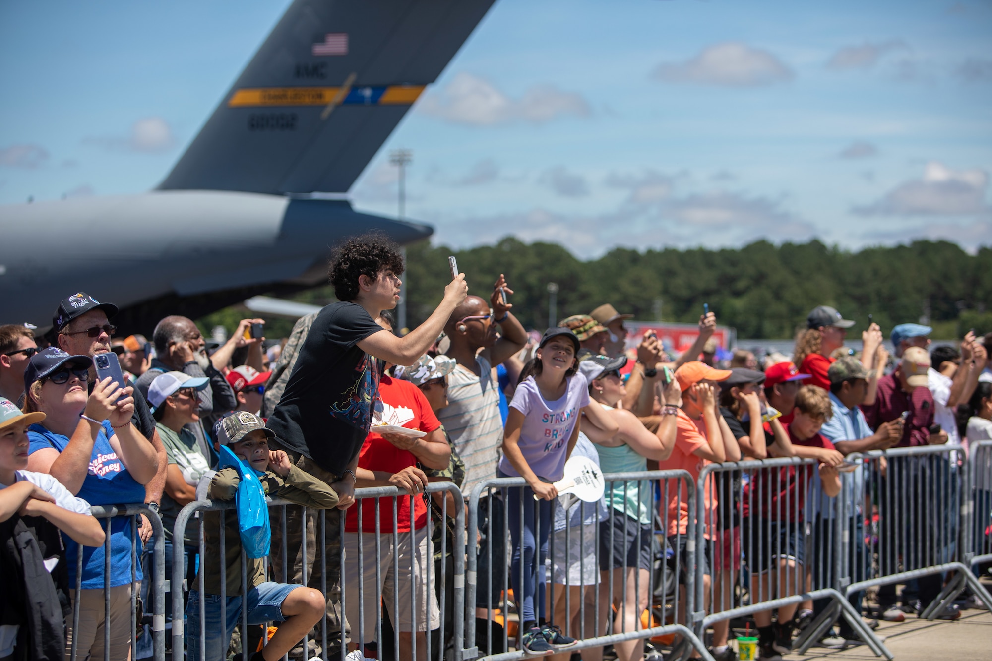 Spectators watch as various aircraft perform aerial manuevers during the 2023 Wings Over Wayne air show at Seymour Johnson Air Force Base, North Carolina, May 20, 2023. Wings Over Wayne provides an opportunity for North Carolina residents and visitors from around the world to see how SJAFB builds to the future of airpower and displays a history of aircraft innovation and capabilities. (U.S. Air Force photo by Staff Sgt. Koby I. Saunders)