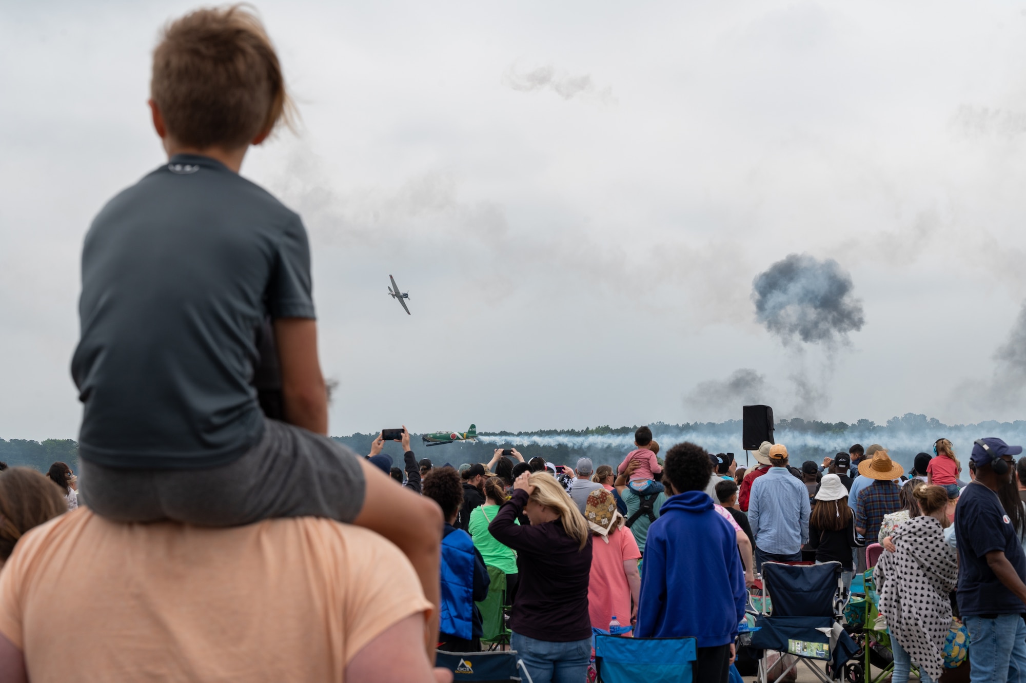 Spectators watch as various aircraft perform aerial maneuvers during the 2023 Wings Over Wayne air show at Seymour Johnson Air Force Base, North Carolina, May 21, 2023. Wings Over Wayne provides an opportunity for North Carolina residents and visitors from around the world to see how SJAFB builds to the future of airpower and displays a history of aircraft innovation and capabilities. (U.S. Air Force photo by Airman 1st Class Leighton Lucero)