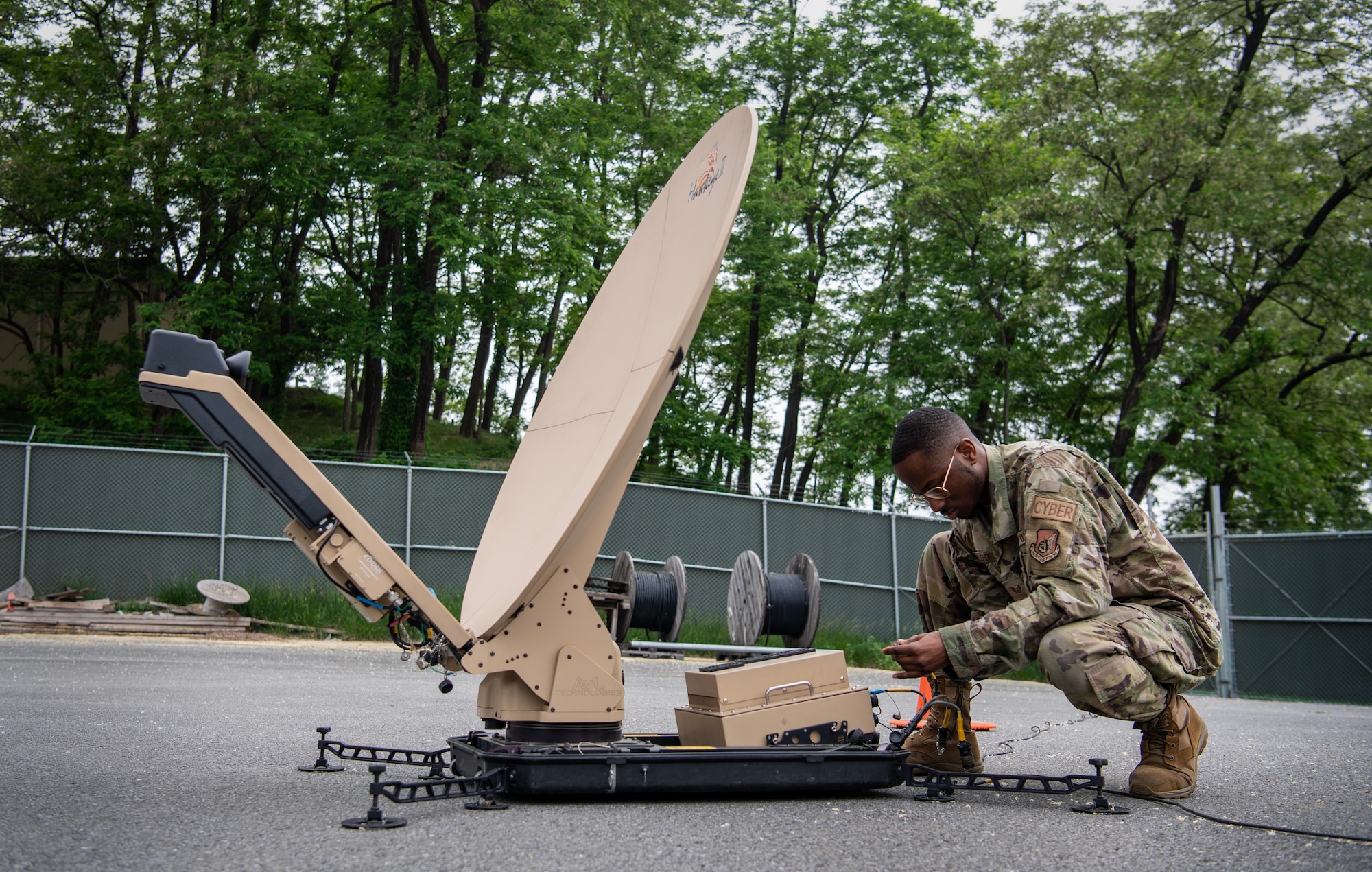 U.S. Air Force Staff Sgt. Christopher Florence, 607th Air Communications Squadron, NCO in charge of the radio satellite communications shop, sets up a Hawkeye antenna during exercise Enduring PACE, May 18, 2023, at Osan Air Base, Republic of Korea.