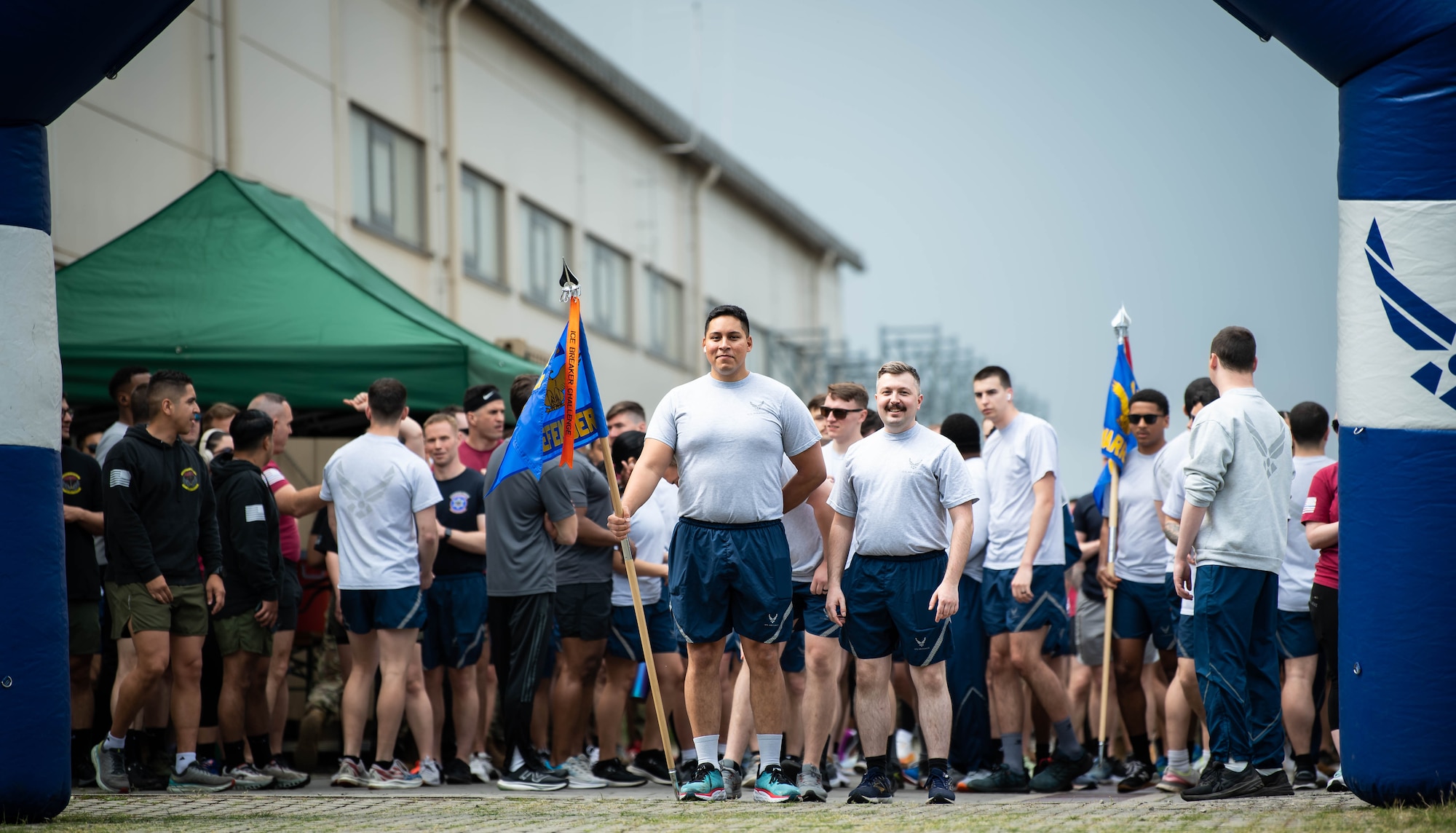 U.S. Air Force Senior Airman Roy Calatayud, center, 1st Combat Communications Squadron communications security responsible officer, and Senior Airman Charles Putnam, right of Calatayud, 721st Aircraft Maintenance Squadron avionics journeyman, stand at the starting line of a 5k during Police Week at Ramstein Air Base, Germany, May 15, 2023. During the week, the base held several events honoring Police Week including a Defender Challenge, 5K run and a final guardmount. (U.S. Air Force photo by Airman 1st Class Jared Lovett)
