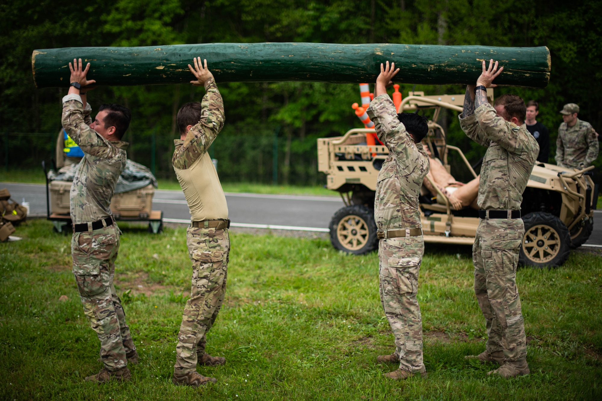 Contingency Response team members assigned to the 435th Security Forces Squadron perform log presses as part of the Defender Challenge during Police Week at Ramstein Air Base, Germany, May 16, 2023. The Defender Challenge consisted of a timed ruck, a log press and carry, a downed vehicle push, combat life-saver training and a scavenger hunt. (U.S. Air Force photo by Airman 1st Class Jared Lovett)