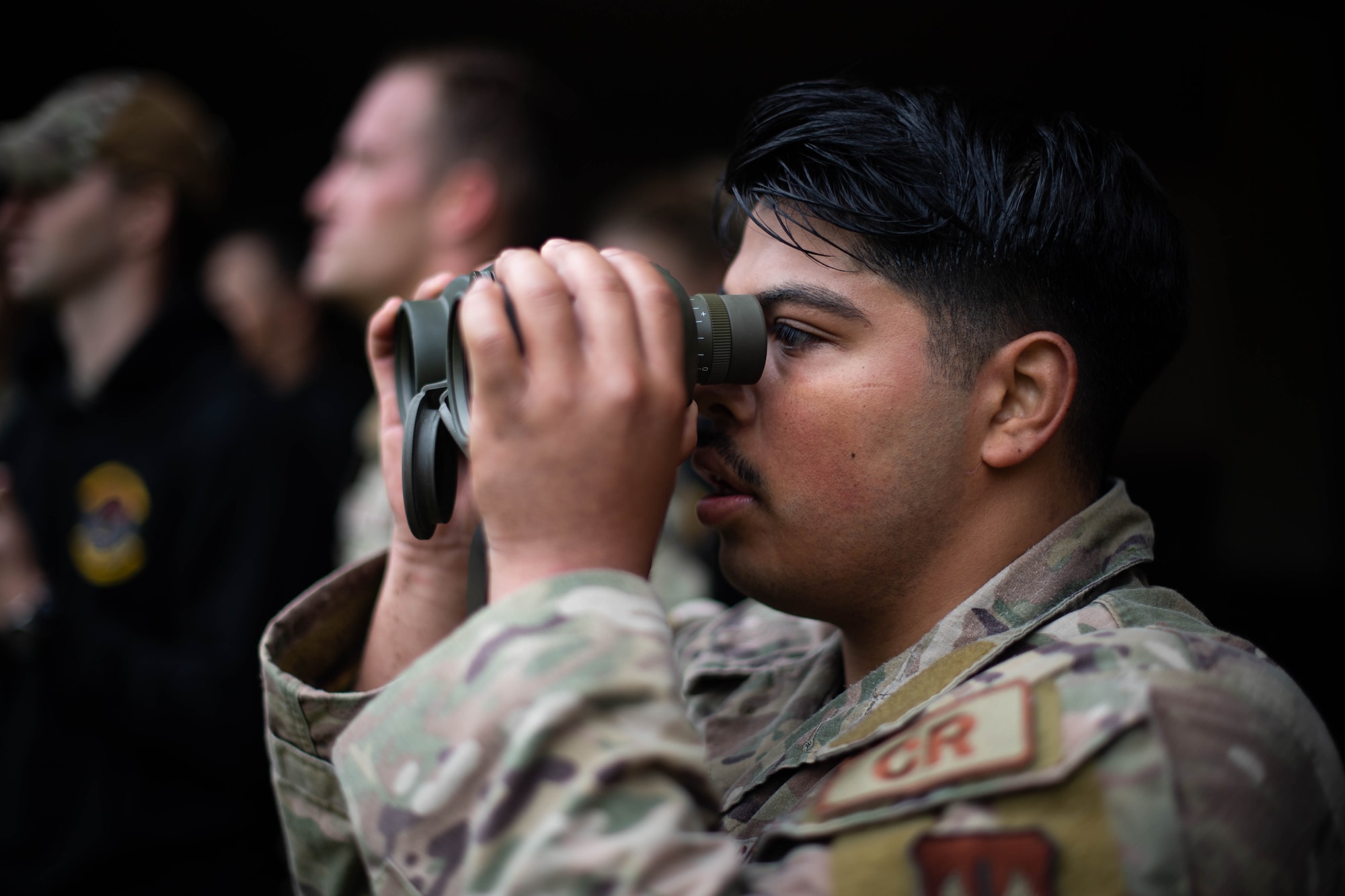 U.S. Air Force Staff Sgt. Jesus Solis-zavala, 435th Security Forces Squadron Contingency Response team member, searches for abnormalities in the environment as part of the Defender Challenge during Police Week at Ramstein Air Base, Germany, May 16, 2023. The Defender Challenge consisted of a timed ruck, a log press and carry, a downed vehicle push, combat life-saver training and a scavenger hunt. (U.S. Air Force photo by Airman 1st Class Jared Lovett)