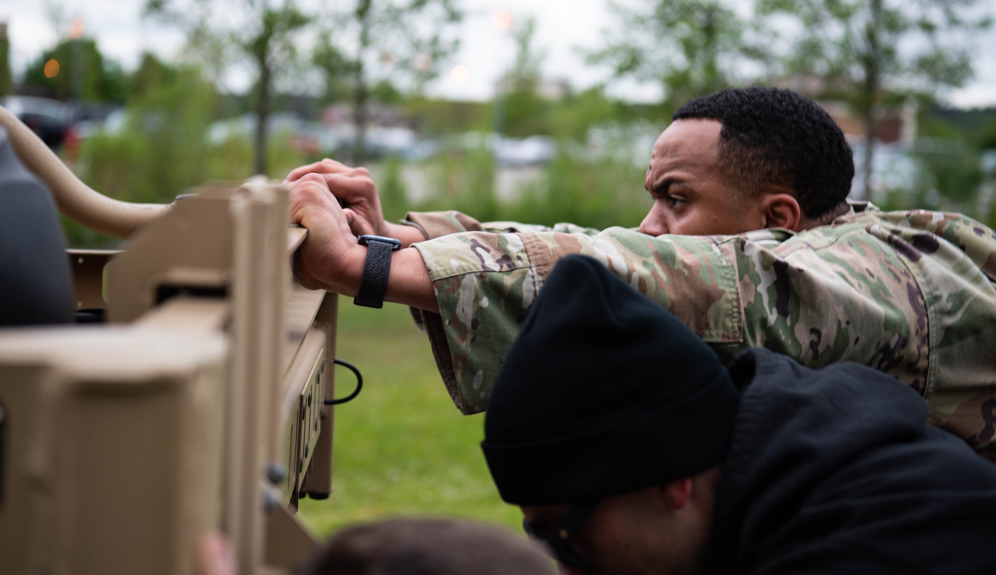 U.S. Air Force Airmen assigned to the 86th Security Forces Squadron, push a Polaris RZR vehicle during a Police Week event at Ramstein Air Base, Germany, May 16, 2023. The Defender Challenge consisted of a timed ruck, a log press and carry, a downed vehicle push, combat life-saver training and a scavenger hunt. (U.S. Air Force photo by Airman 1st Class Jared Lovett)