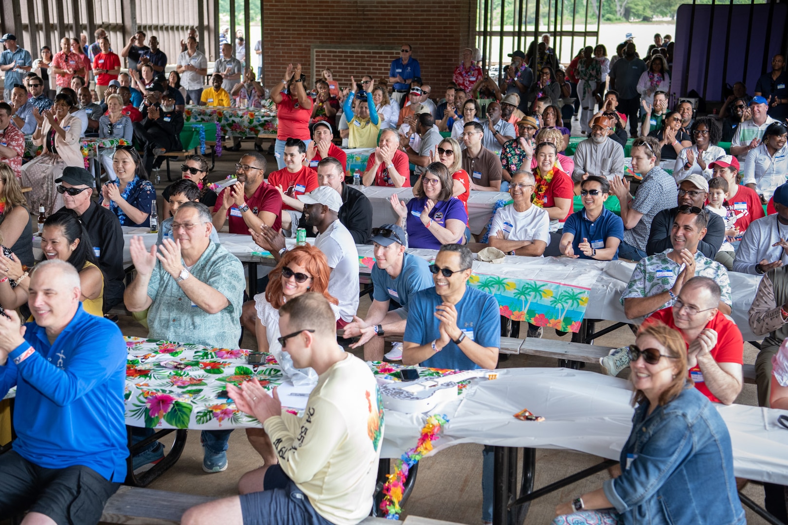 a large crowd in a picnic pavillion