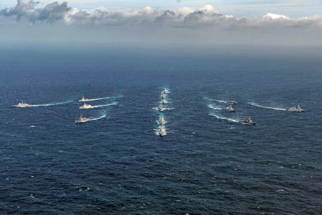Ships steam in formation.