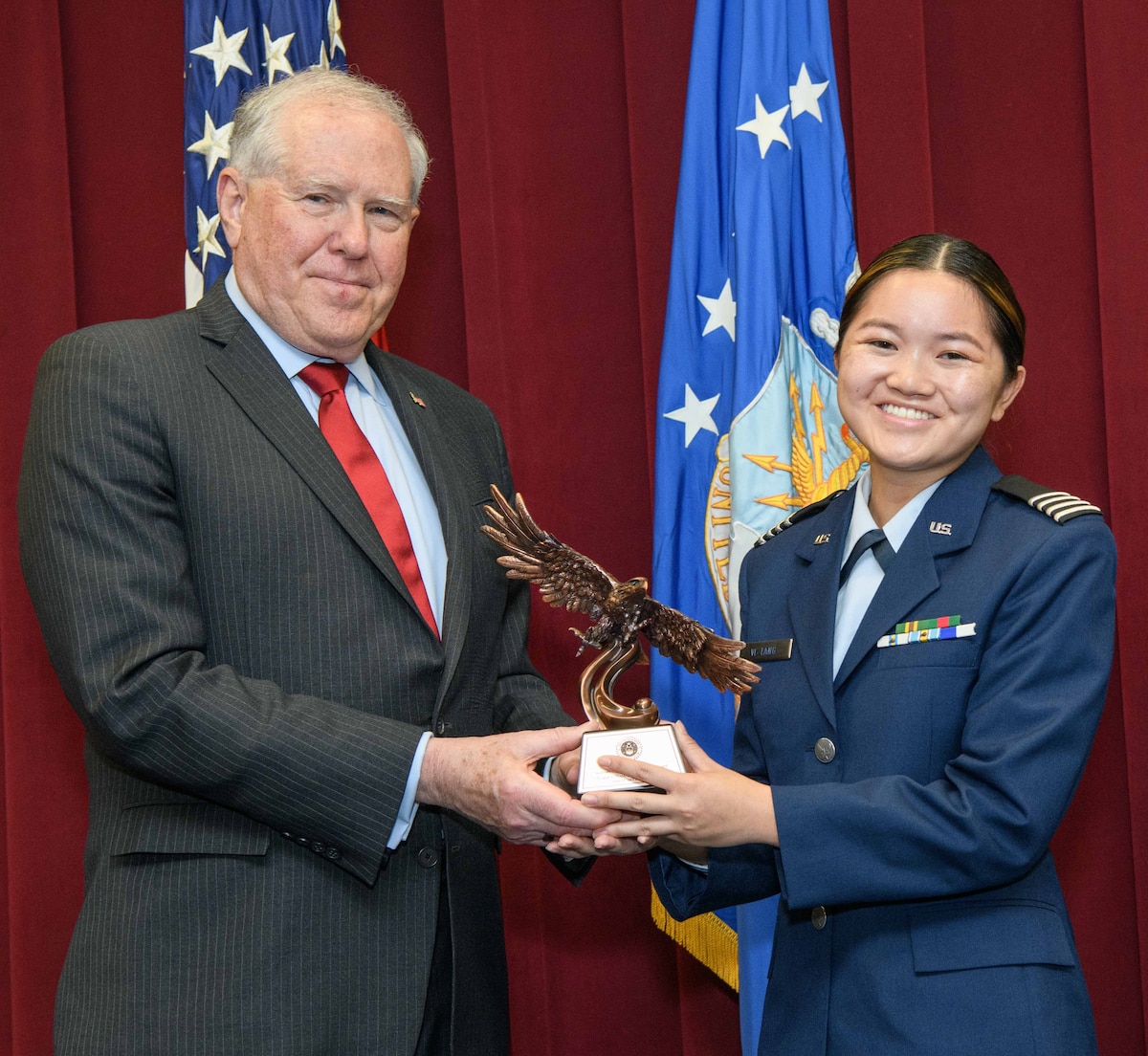 Secretary of the Air Force Frank Kendall presents a Secretary of the Air Force 2022 Leadership Award to Air Force ROTC Cadet Samantha Vi-Tang