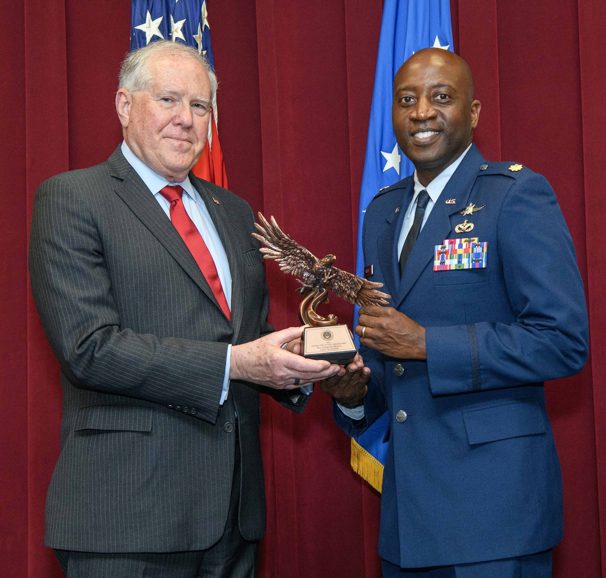 Secretary of the Air Force Frank Kendall presents a Secretary of the Air Force 2022 Leadership Award to Maj. Craig Moore