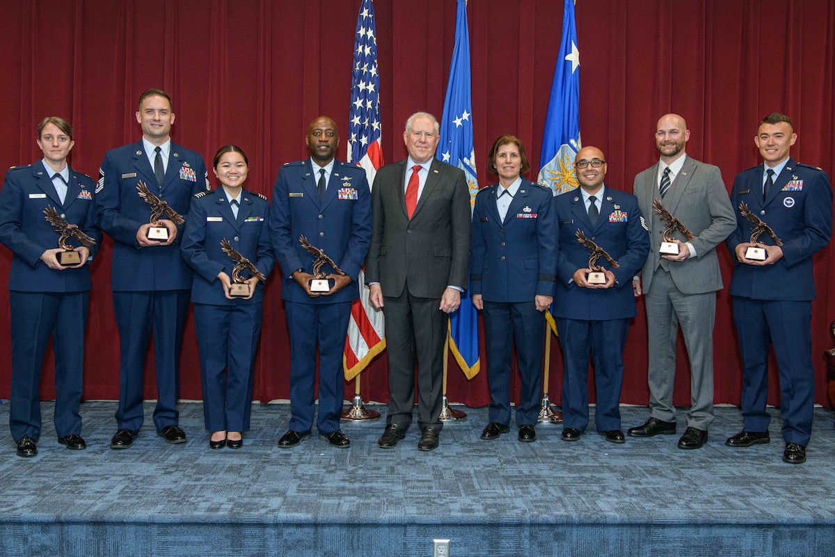 Secretary of the Air Force Frank Kendall (center) presented a Secretary of the Air Force 2022 Leadership Award to each of several Air University staff, faculty and former students during a ceremony May 9, 2023, Maxwell Air Force Base, Alabama. Pictured to Kendall’s left is Air University Commander and President Lt. Gen. Andrea Tullos. The award is given to those who exhibited exemplary leadership, character and ethical behavior and is the most prestigious award given by Air University on behalf of the secretary of the Air Force. Recipients from left to right are Maj. Kelsey Payton, student, Air Command and Staff College; Senior Master Sgt. Justin Baker, student, Air Force Senior Noncommissioned Officer Academy; Air Force ROTC Cadet Samantha Vi-Tang, University of California-Los Angeles Detachment 055; Maj. Craig Moore, Air Force ROTC Detachment 025, Arizona State University; Tech. Sgt. Jose Rivera, Community College of the Air Force; William Tooke, Air Force SNCOA; and Maj. Sergei McNulty, Air Force Officer Training School. Not available for the presentation was Senior Master Sgt. Enrique Moore, education directorate, Thomas N. Barnes Center for Enlisted Education. (U.S. Air Force photo by Trey Ward)