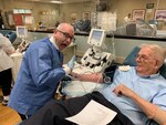Ty Allen, from the Fort Bragg Blood Donor Center prepares Al Whintey for his platelet donation.