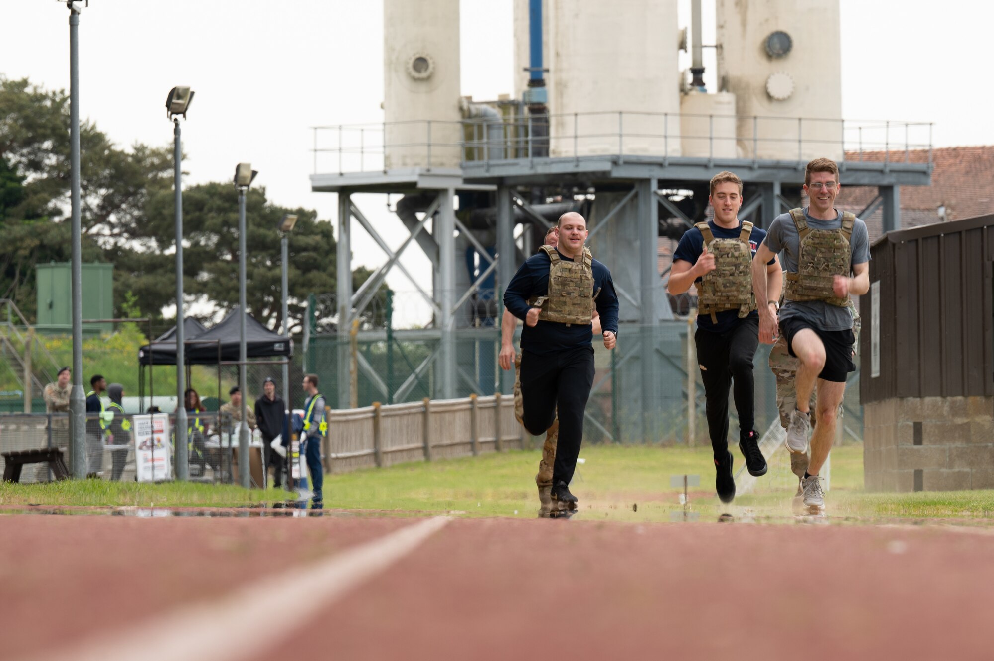 U.S. Air Force Airmen assigned to the 100th Civil Engineer Squadron, sprint to the next obstacle during the defenders challenge for police week at Royal Air Force Mildenhall, England, May 18, 2023.