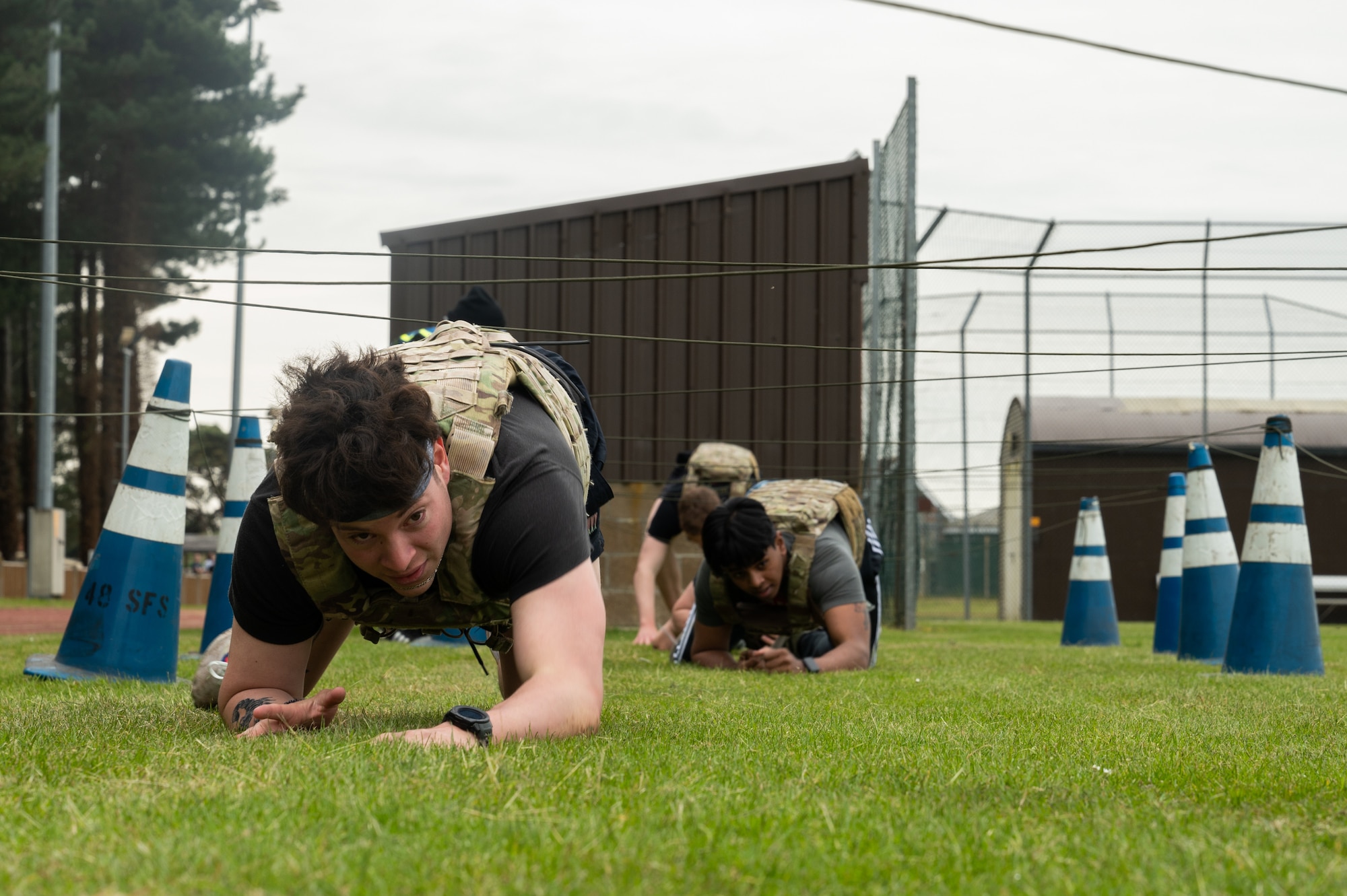 U.S. Air Force Airmen assigned to the 100th Security Forces Squadron, low crawl during the defender challenge course at Royal Air Force Mildenhall, England, May 18, 2023.